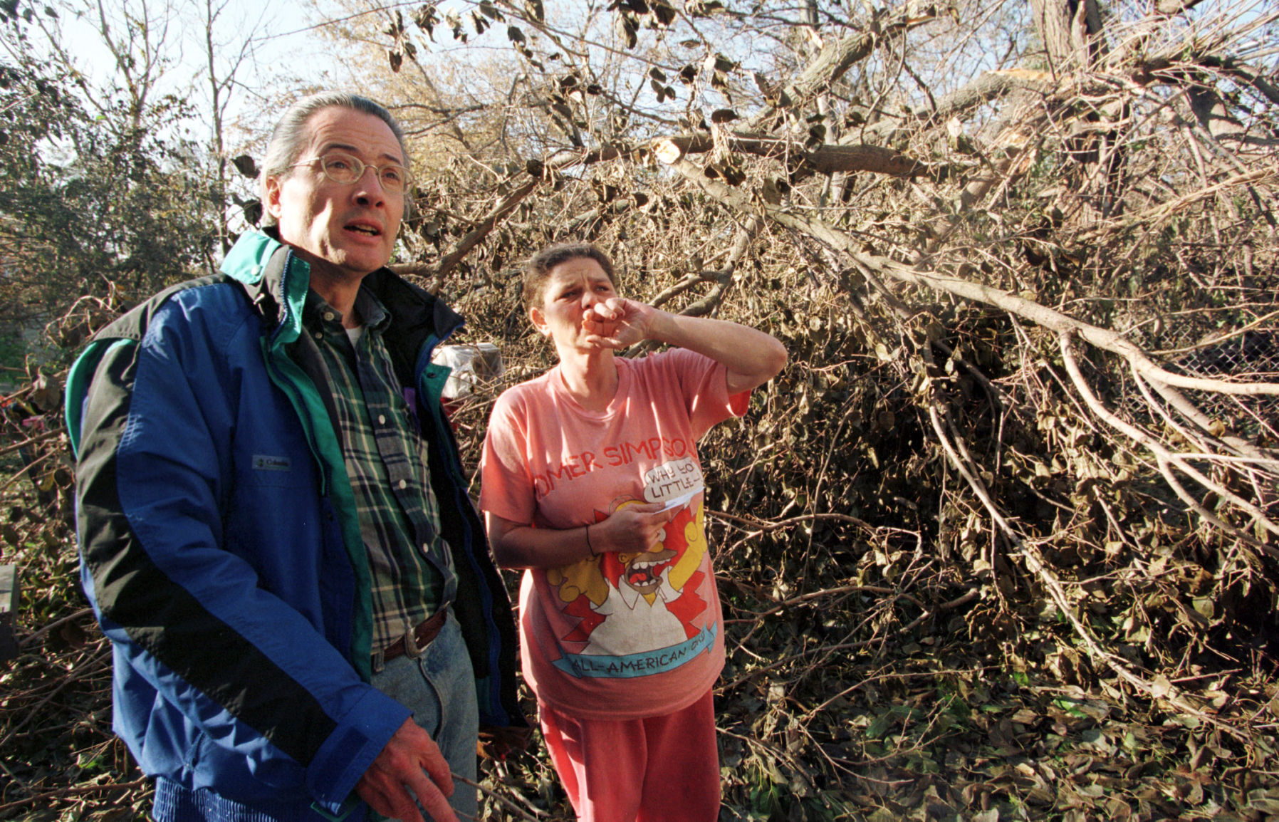 Omaha Mayor Hal Daub talks with Peggy Russell in her backyard at 2008 S. 25th St. Thursday afternoon, Oct. 30, 1997. The tree behind her is her neighbor's tree, but it landed in her yard, and she also has a tree limb that landed on her roof of the house she rents.